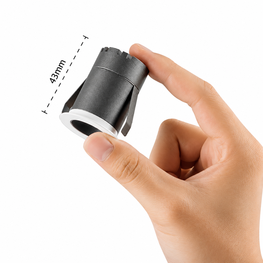 Compact MICRO 30 architectural mini LED downlight shown in hand to illustrate its ultra-compact 30 mm cut-out size.