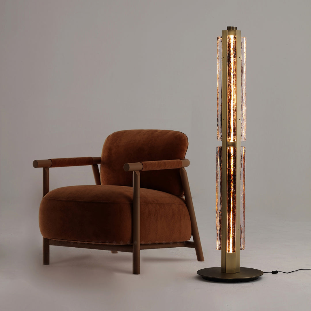 Designer floor lamp beside armchair, hand-blown textured glass ambient lighting for modern living room