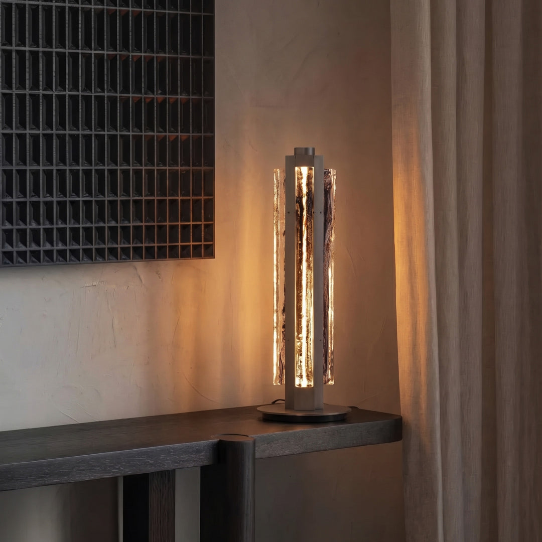 Modern designer table lamp creating warm ambient lighting in interior, Running Water Trio glass lamp