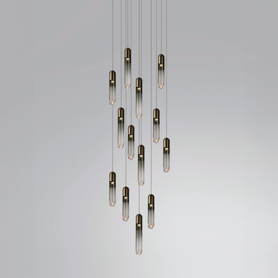 Modern hand-blown glass chandelier for stair void with cascading capsule pendants