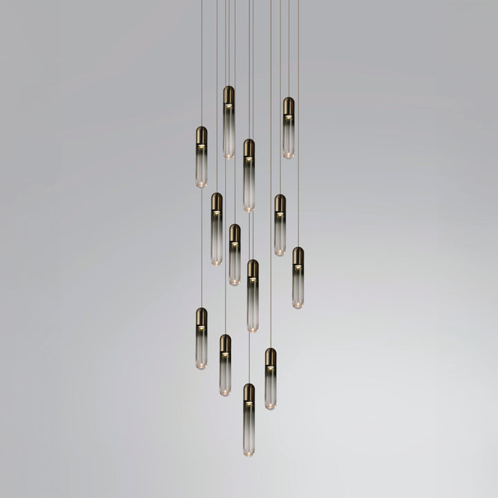 Modern hand-blown glass chandelier for stair void with cascading capsule pendants