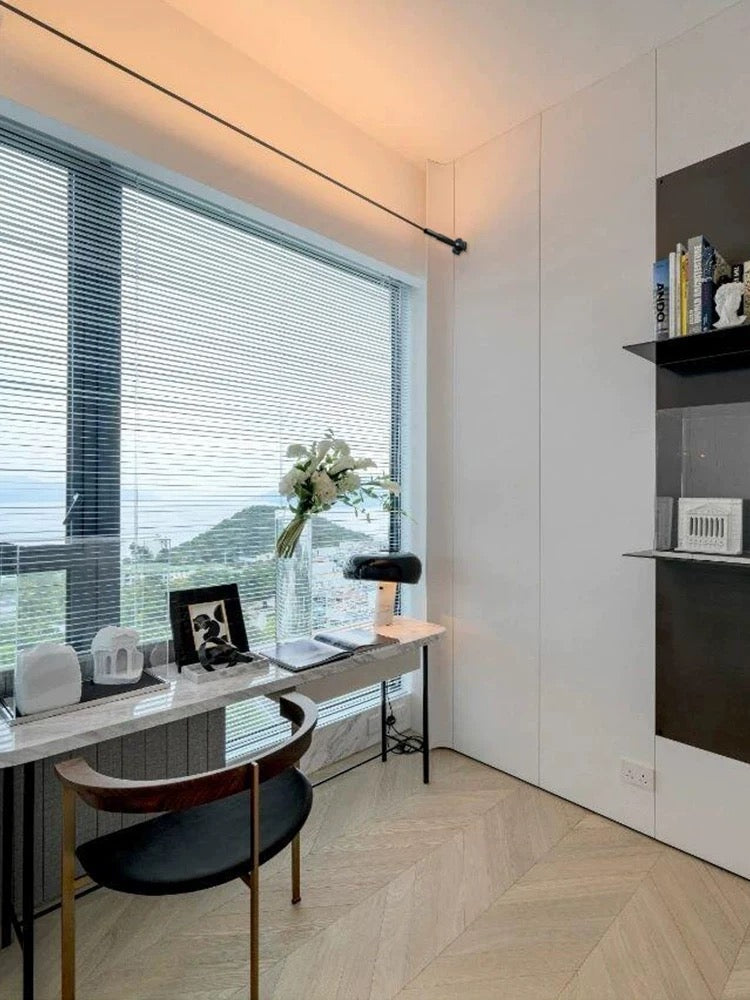 modern linear LED ceiling light providing soft ambient illumination in a bright living room near large windows