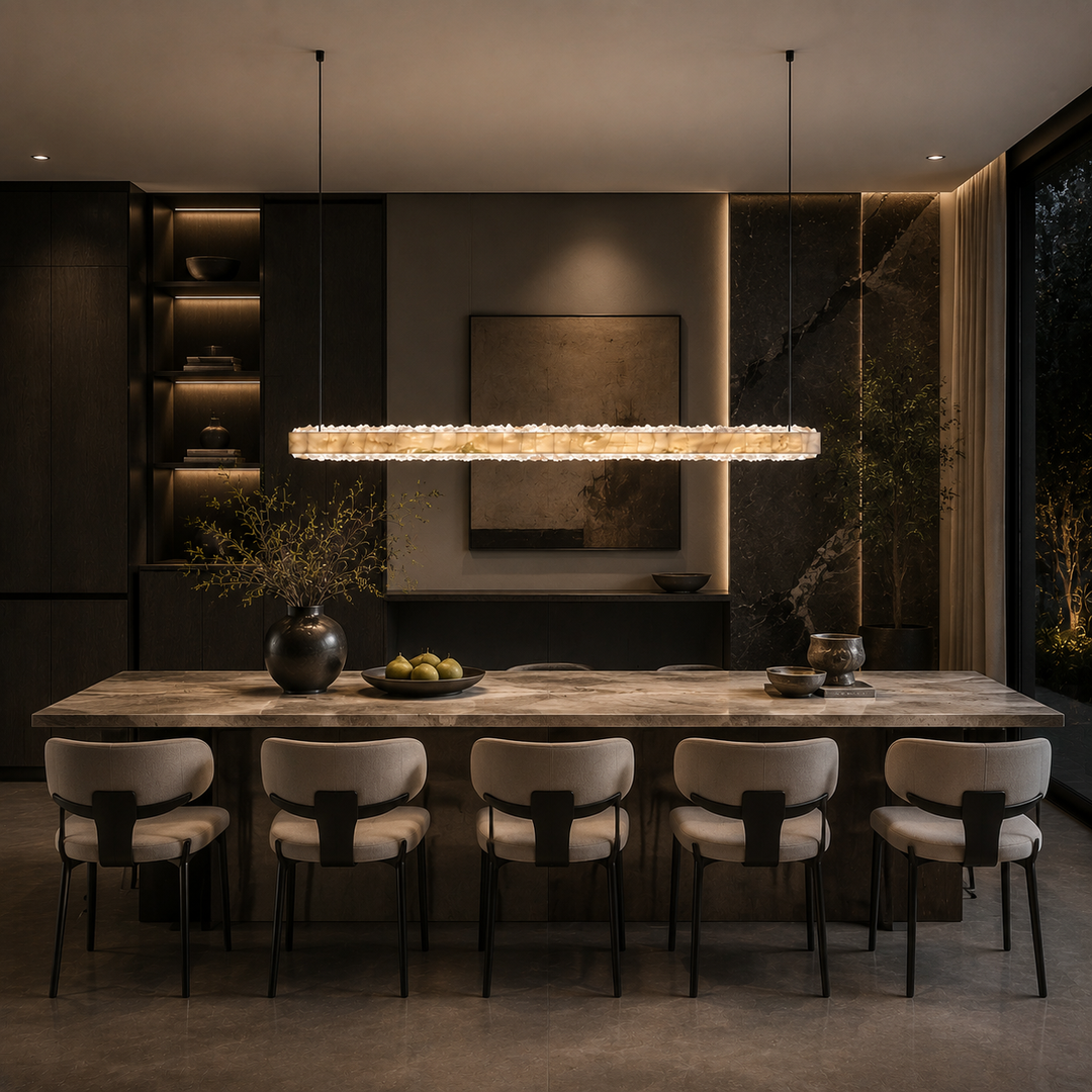 Modern marble and crystal linear pendant light over a dining table, handcrafted natural stone and crystal LED chandelier for luxury residential and architectural interiors.