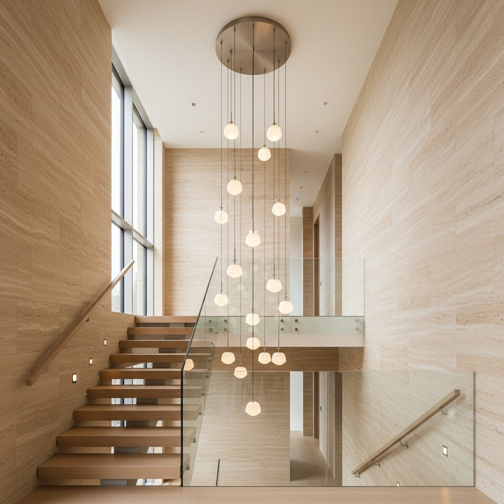 Multi-drop cluster pendant light installed in double-height staircase interior