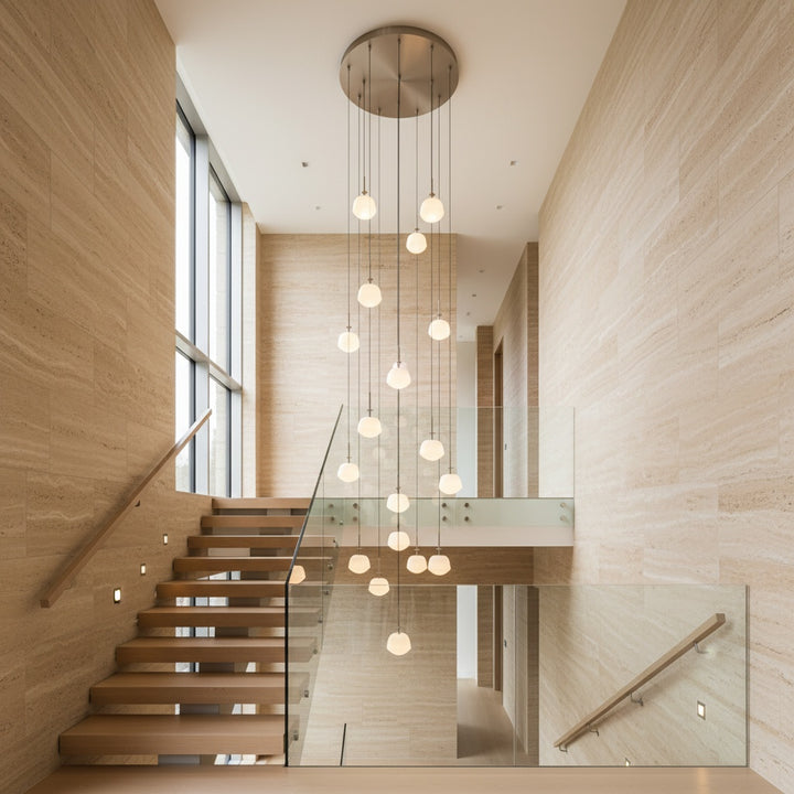 Multi-drop cluster pendant light installed in double-height staircase interior