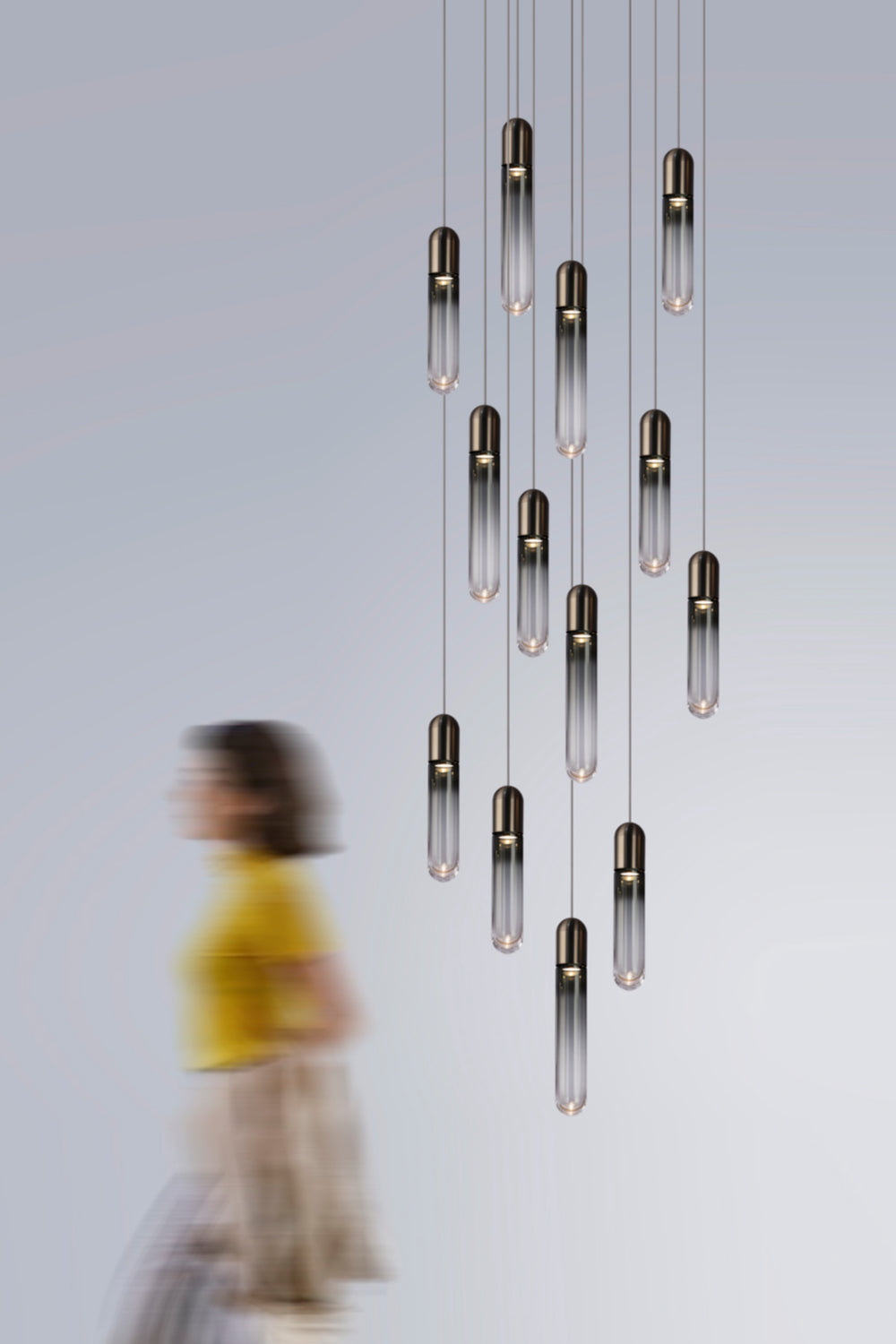 Multi-drop hand-blown glass chandelier in double height stair void space