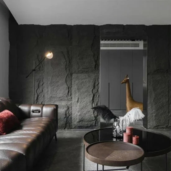 Lightweight rock-look wall panels creating a dramatic MushRock feature wall in a modern living room interior.