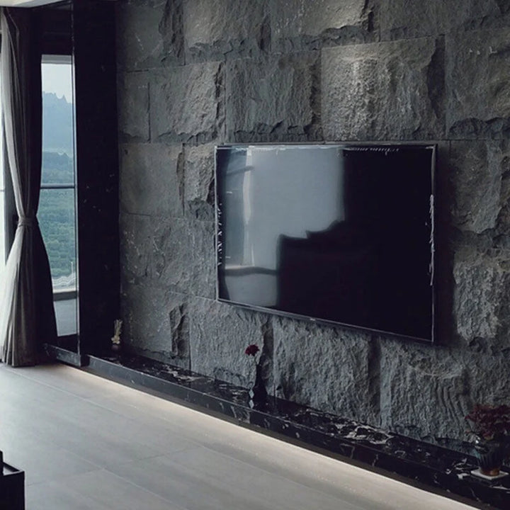 Lightweight MushRock rock-look wall panels installed on a modern interior wall with realistic stone texture.