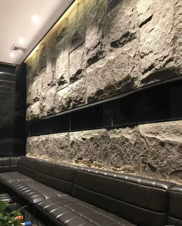 Textured MushRock rock-look wall panels with integrated lighting creating a dramatic feature wall.