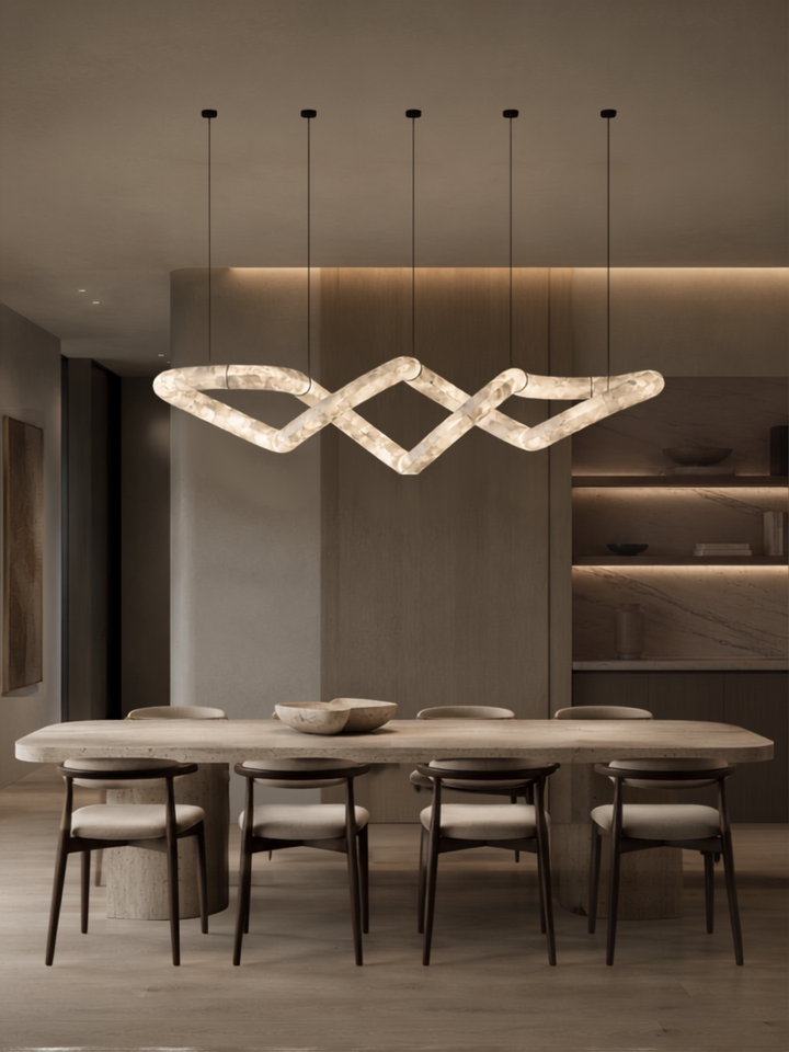 Nexus Spanish Alabaster Linear Pendant Light above a luxury dining table with handcrafted Spanish alabaster and bespoke brass detailing.