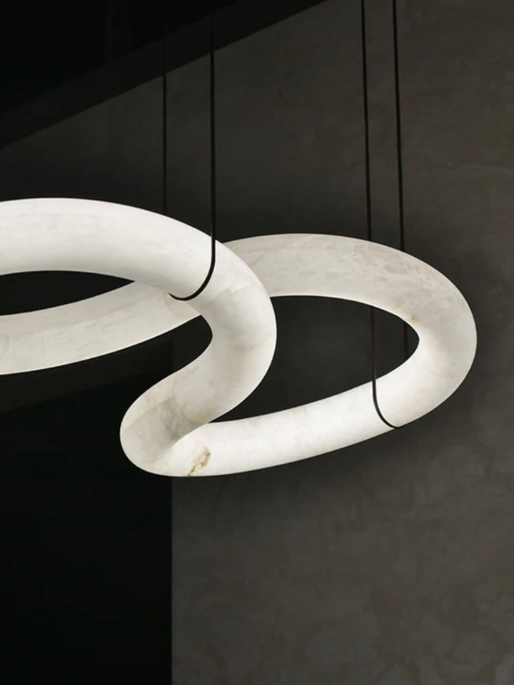 Close-up of the Nexus Spanish Alabaster Loop pendant light showcasing genuine Spanish alabaster and sculptural loop design.
