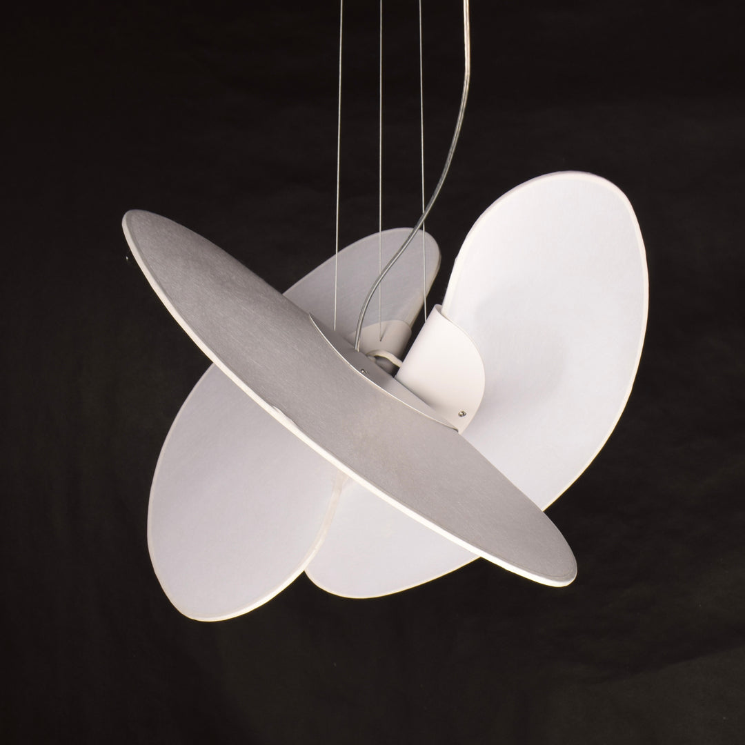 an organic ambient pendant light with layered forms suspended in space, producing gentle diffused illumination and a sense of visual movement