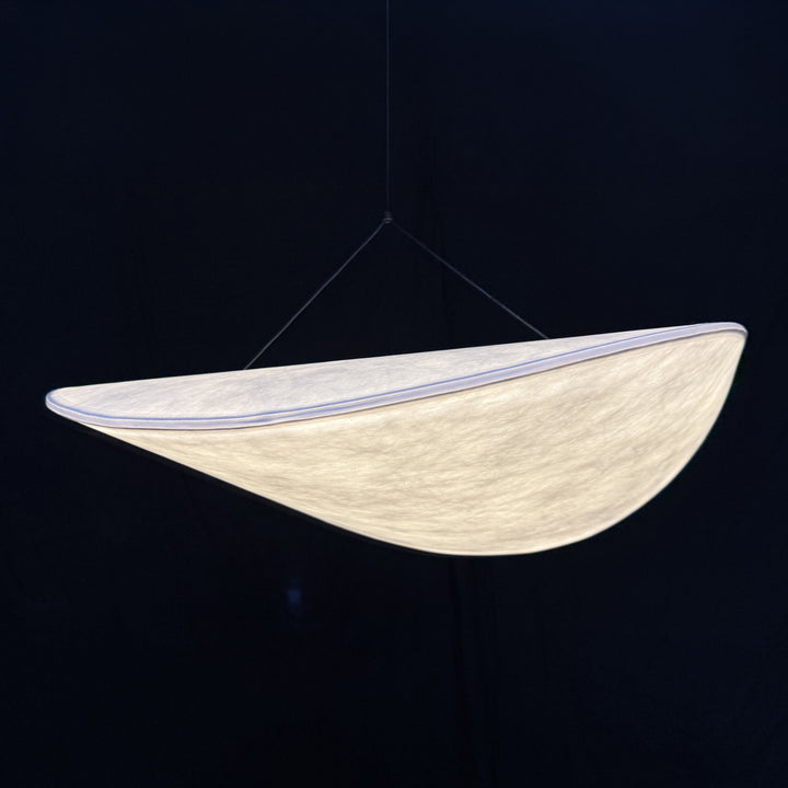 a close-up view of an organic cocoon-style pendant light with soft diffused illumination and a smooth, atmospheric glow