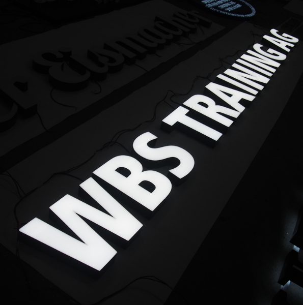 Outdoor front lit LED channel letter signage with white illuminated letters for commercial use