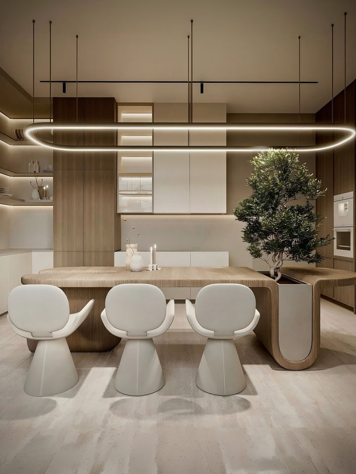 Custom oval LED ring pendant light centred above a modern dining table in a warm neutral interior, front view with sculptural white chairs, Oval LED Ring Bespoke Lighting by Lucretia