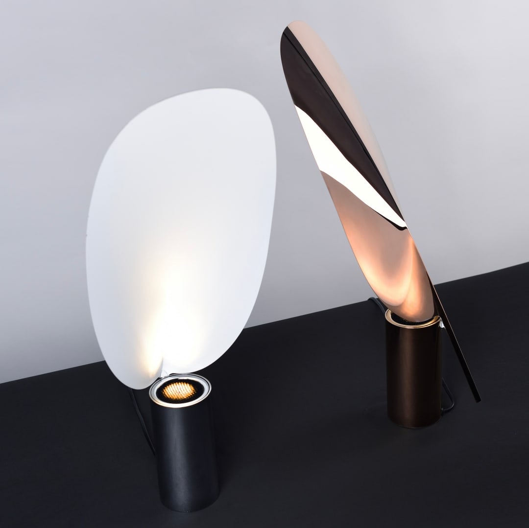 Palm Table Lamp with white rounded shade and refined metal base, providing warm ambient lighting for bedside tables and modern living spaces.