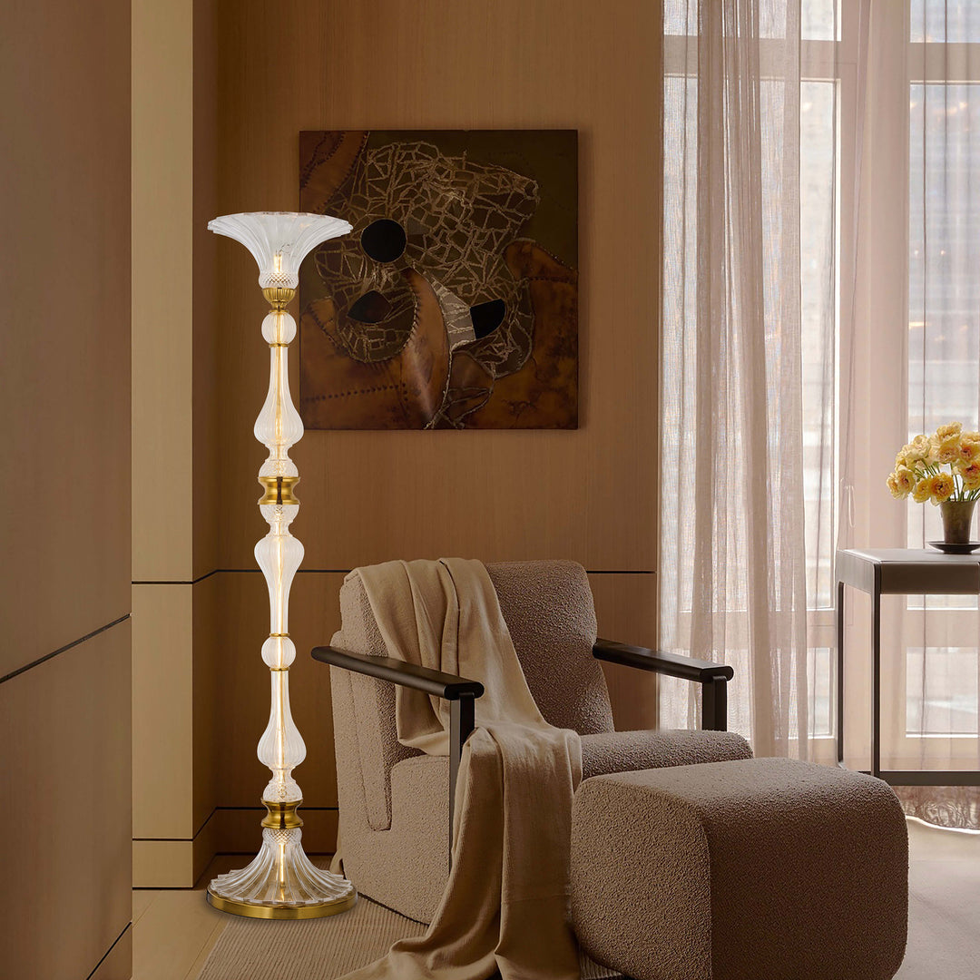 Petaluxe L Floor Lamp with hand-blown glass creating warm ambient lighting in a luxury living room.