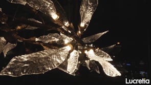 Nature-inspired wall lamp with sculpted glass leaves emitting warm ambient LED glow, luxury feature wall lighting for modern interiors