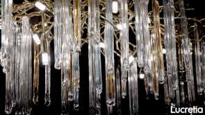 Close-up detail of Lucretia glazed icicle brass chandelier showing hand-crafted brass frame and custom glass icicle crystal lighting elements