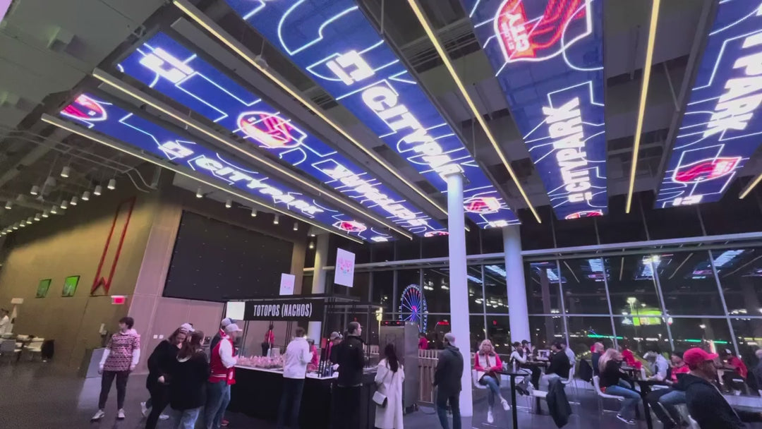 Architectural LED Mesh Ceiling Display installed in a commercial entertainment venue with suspended transparent LED mesh panels and dynamic digital content.