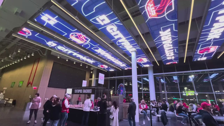Architectural LED Mesh Ceiling Display installed in a commercial entertainment venue with suspended transparent LED mesh panels and dynamic digital content.