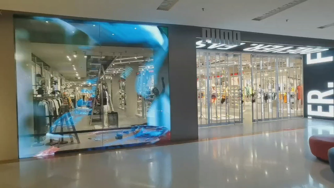 Holographic LED Display installed on a retail glass storefront, creating transparent digital advertising while maintaining full visibility through the glazing.
