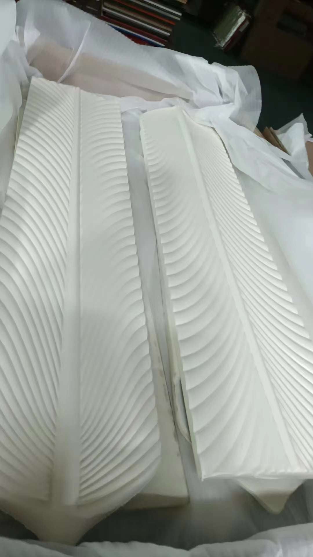 PU feather wall panels showing lightweight polyurethane material and stacked panel form