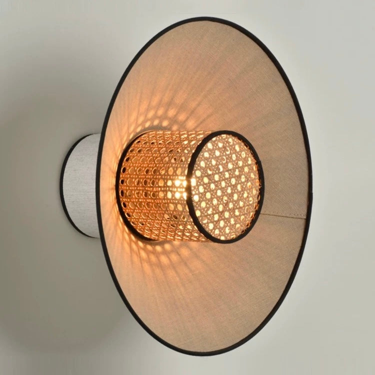 woven rattan wall lamp providing warm ambient lighting in a modern interior setting