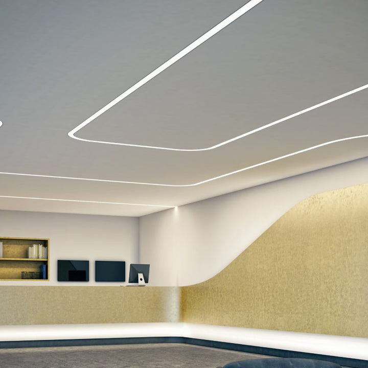 Recessed curved LED linear lighting installed in a commercial ceiling with seamless architectural light lines
