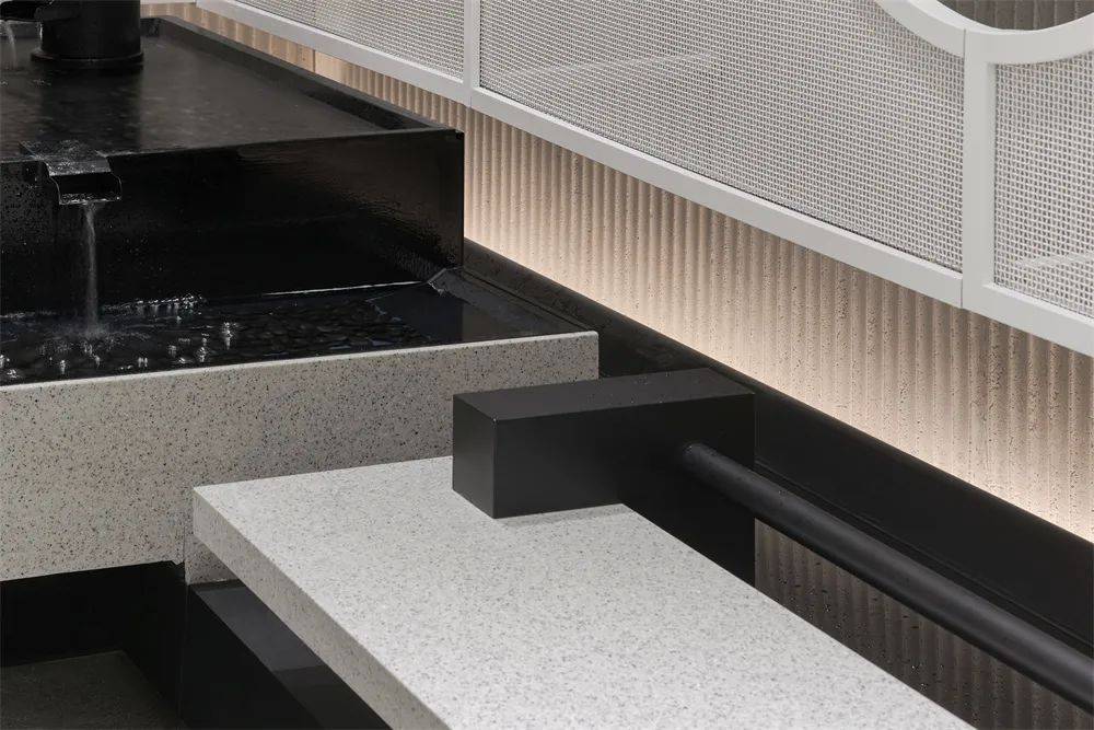 Ripple textured lightweight wall panel detail with integrated lighting in a commercial interior setting
