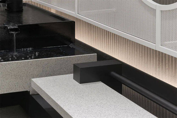 Ripple textured lightweight wall panel detail with integrated lighting in a commercial interior setting
