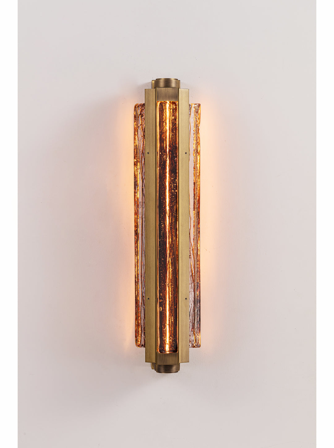 Running Water Trio brass LED wall light featuring three illuminated textured glass elements and a distressed antique brass finish.