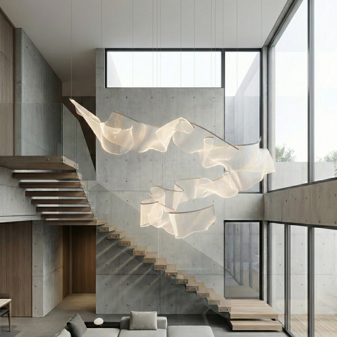 Sculptural acrylic pendant light installed in a modern double-height stair void interior