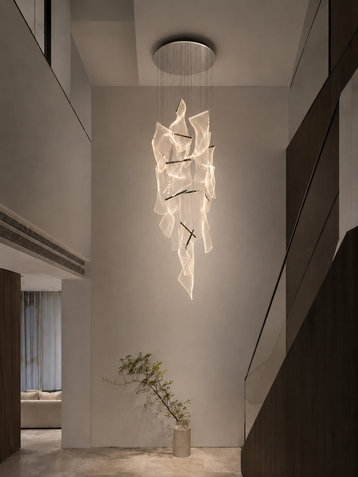 Sculptural German acrylic staircase chandelier in a double-height residential void with minimalist composition and indoor plant, Silken Chandelier 14 by Lucretia