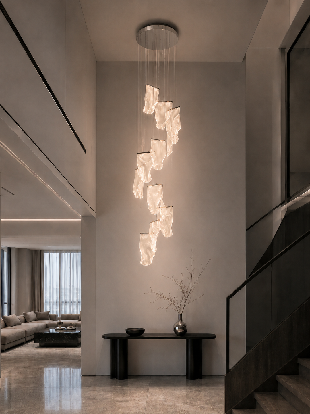 Sculptural German acrylic staircase chandelier in a luxury residential double-height void with console table, decorative vase and open plan living area, Silken Chandelier 14 by Lucretia