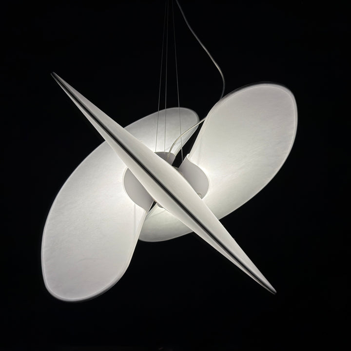 a sculptural ambient pendant light suspended against a dark background, softly diffusing light to create a calm and atmospheric visual presence