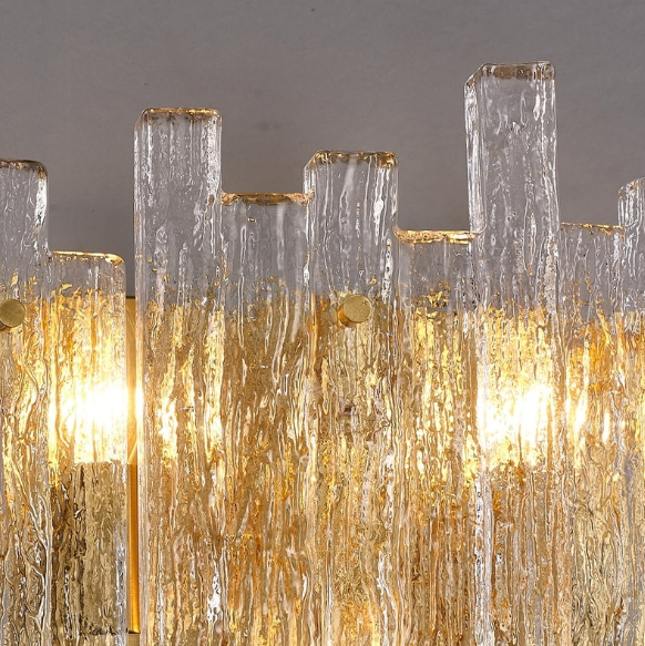 sculptural textured glass wall lamp with brass accents adding elegant ambient illumination to a luxury interior