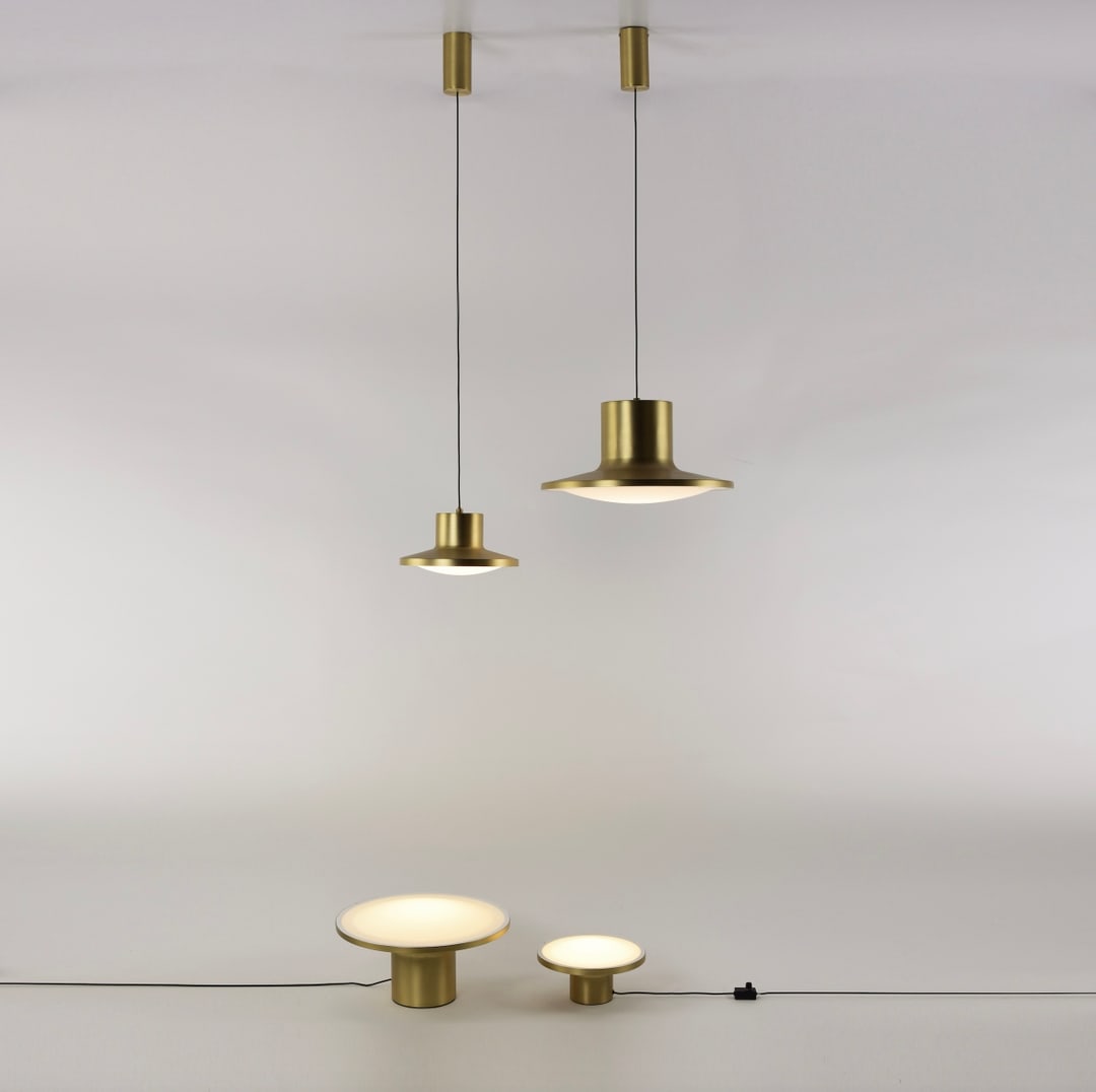 Simbolo lighting series with modern disc-shaped lamps creating a layered lighting effect perfect for residential and commercial interiors.