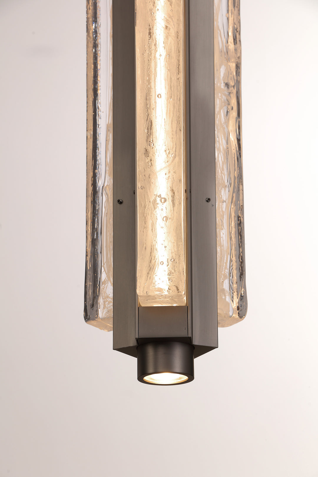 Close-up of smoked clear hand-blown glass pendant light, Running Water trio design with textured finish