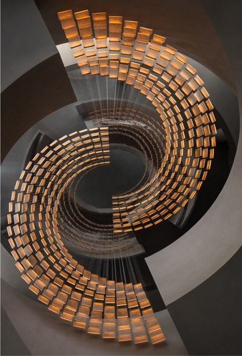 Modern spiral pendant lighting design for staircase voids and luxury architectural interiors.