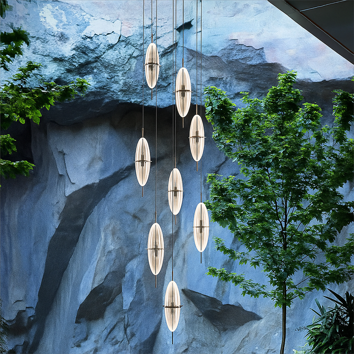 Modern stair void pendant light installation in double-height architectural interior with suspended acrylic lighting elements – Selene