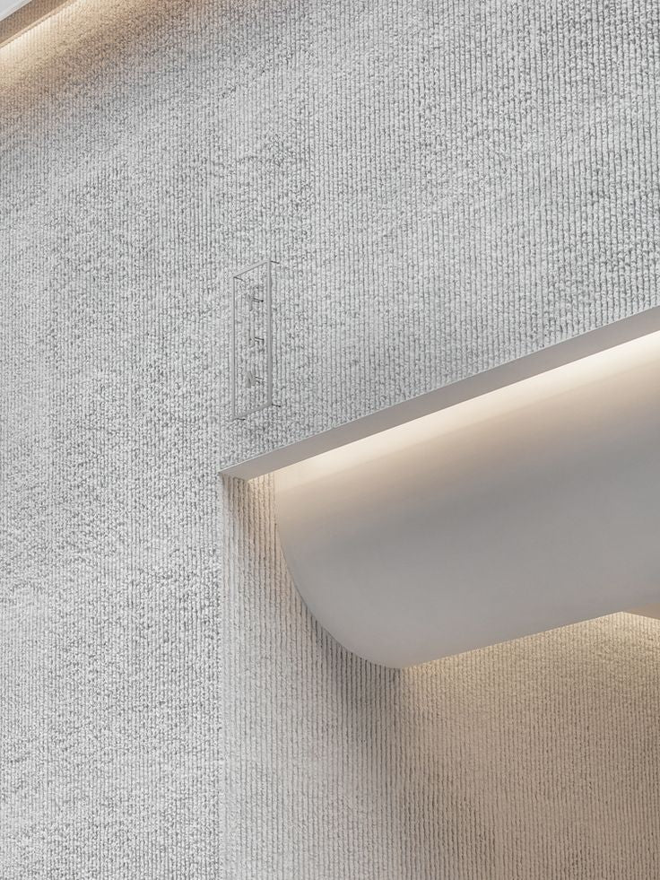 Round line stone wall panels with textured surface highlighted by integrated architectural lighting.