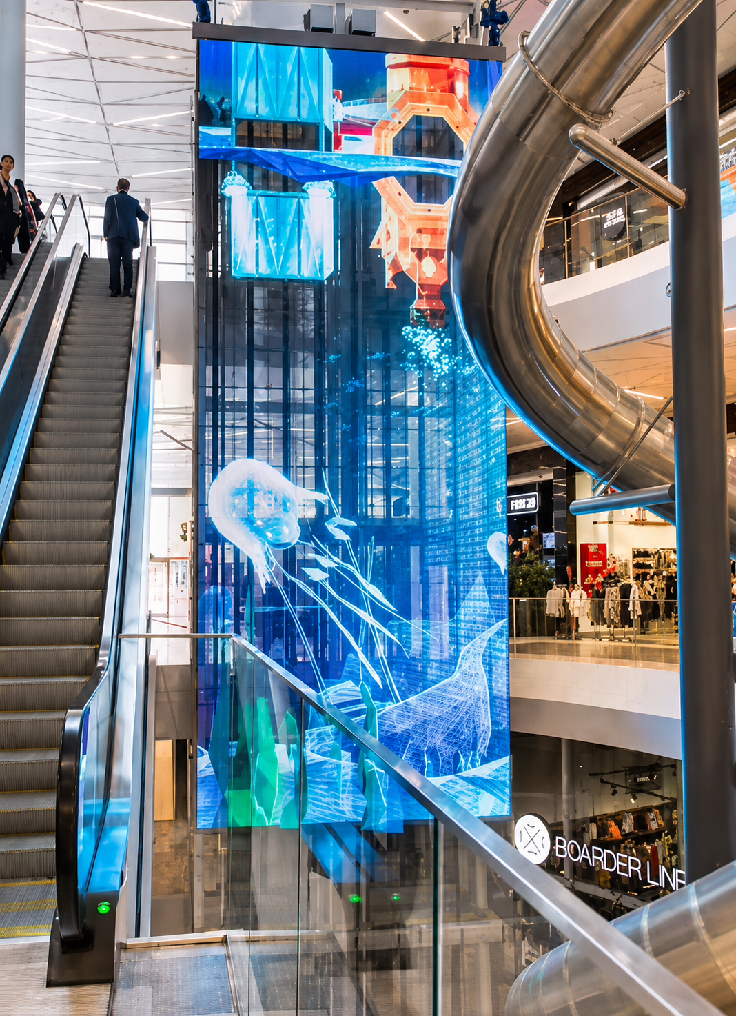 Suspended Transparent LED Mesh Display in a shopping centre atrium