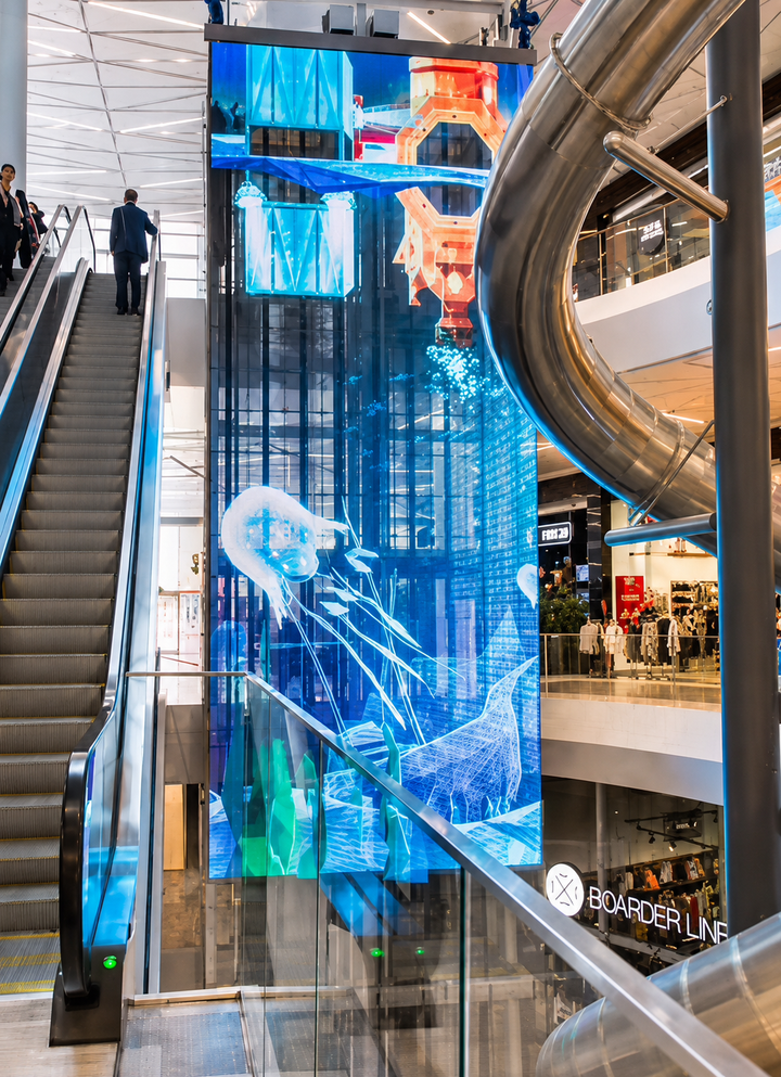 Suspended Transparent LED Mesh Display in a shopping centre atrium