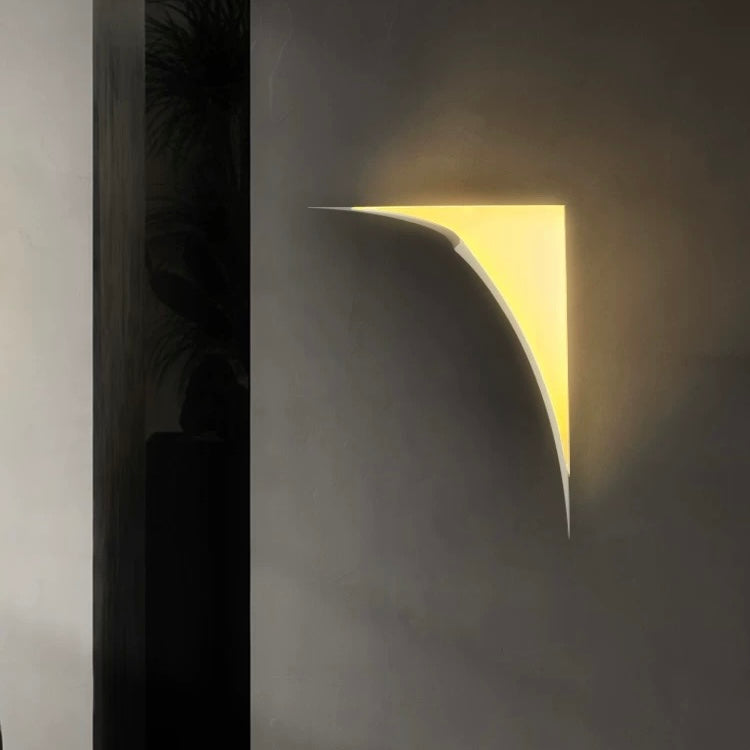 tear shaped gypsum LED wall light creating warm ambient wall lighting on a contemporary feature wall