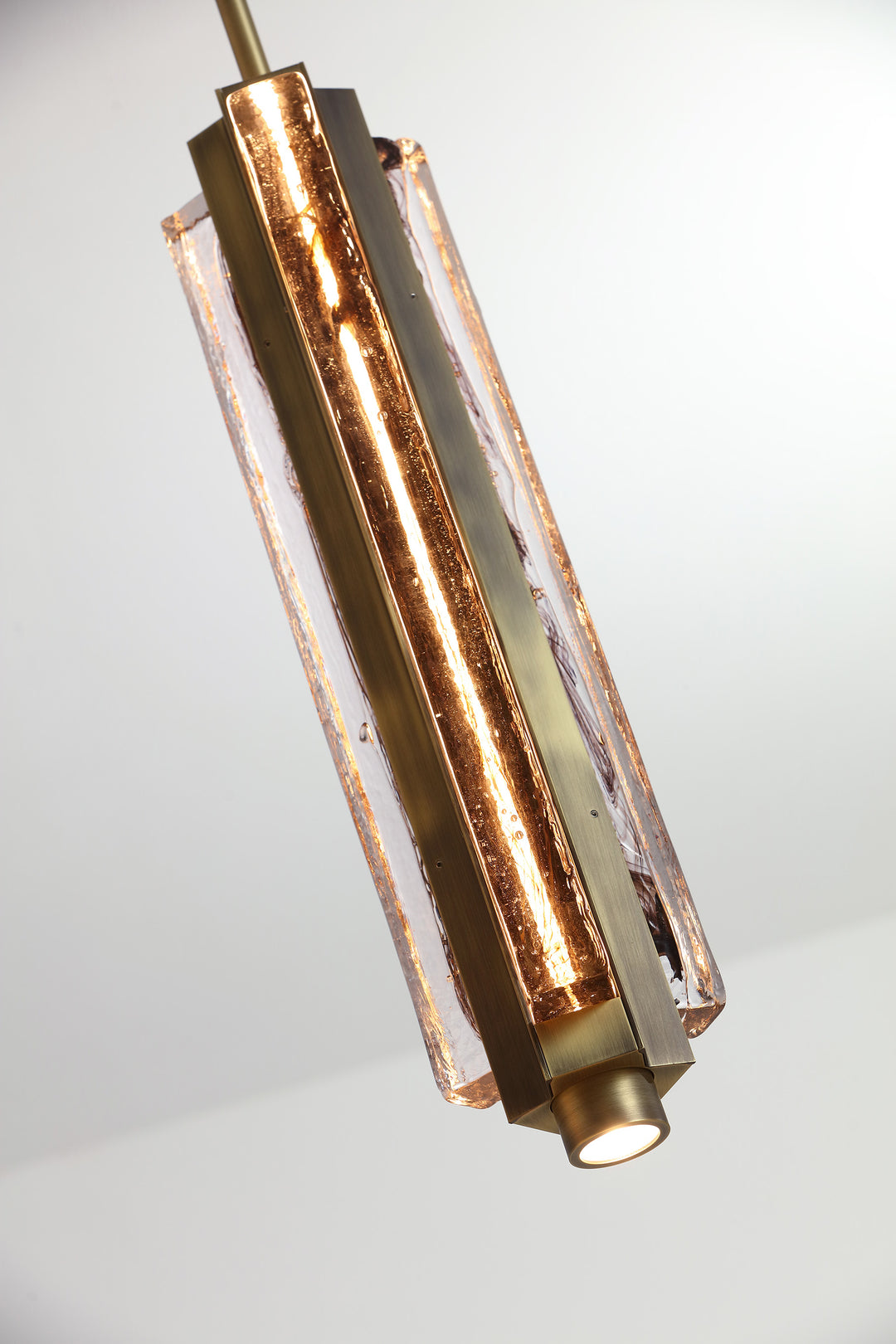 Close-up of hand-blown textured glass pendant light, highlighting Running Water trio design and material detail