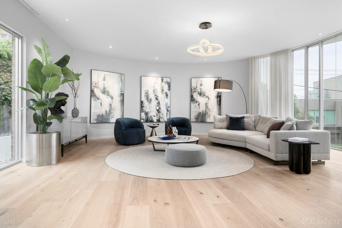 Pharaoh pendant with two interlocking crystal rings above the living room, facing a wall of curved glass