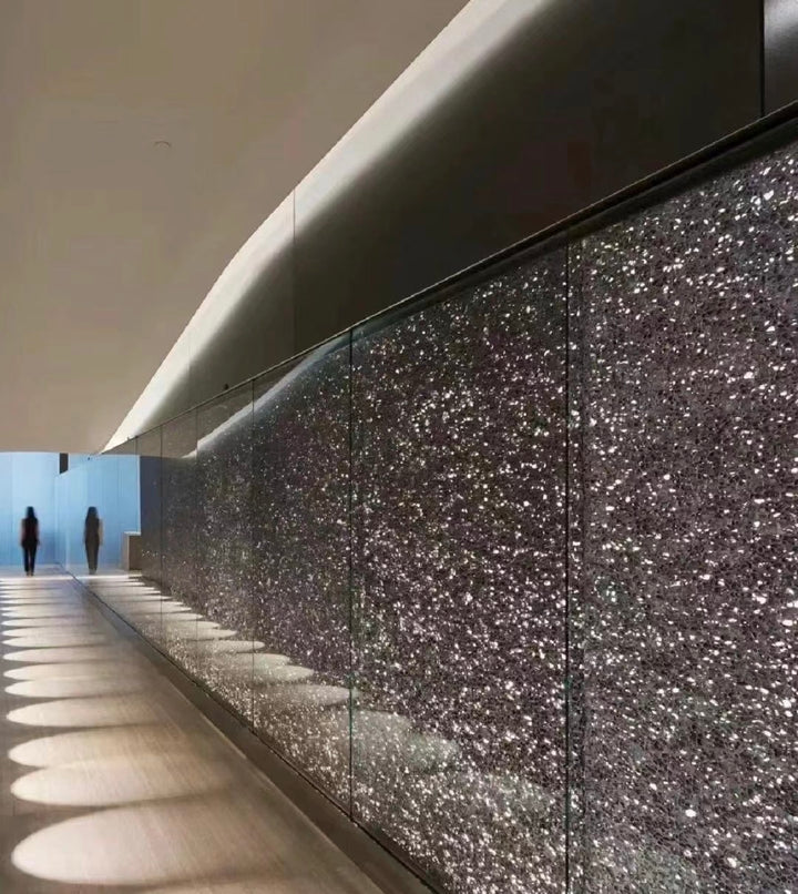 Translucent aluminium foam wall panels used as continuous lighting features in interior architecture