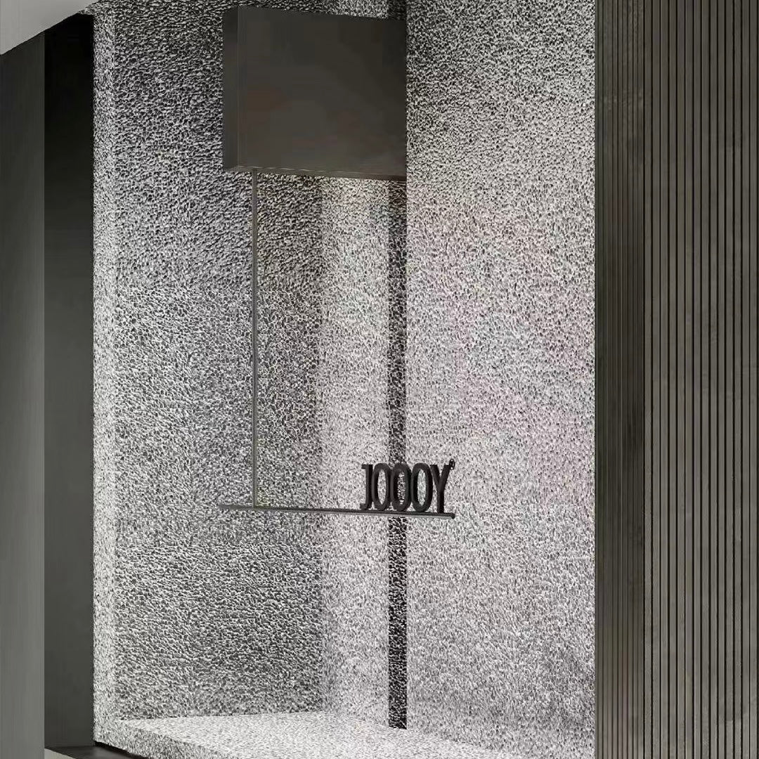 Translucent aluminium foam wall panel used as an illuminated architectural entrance feature