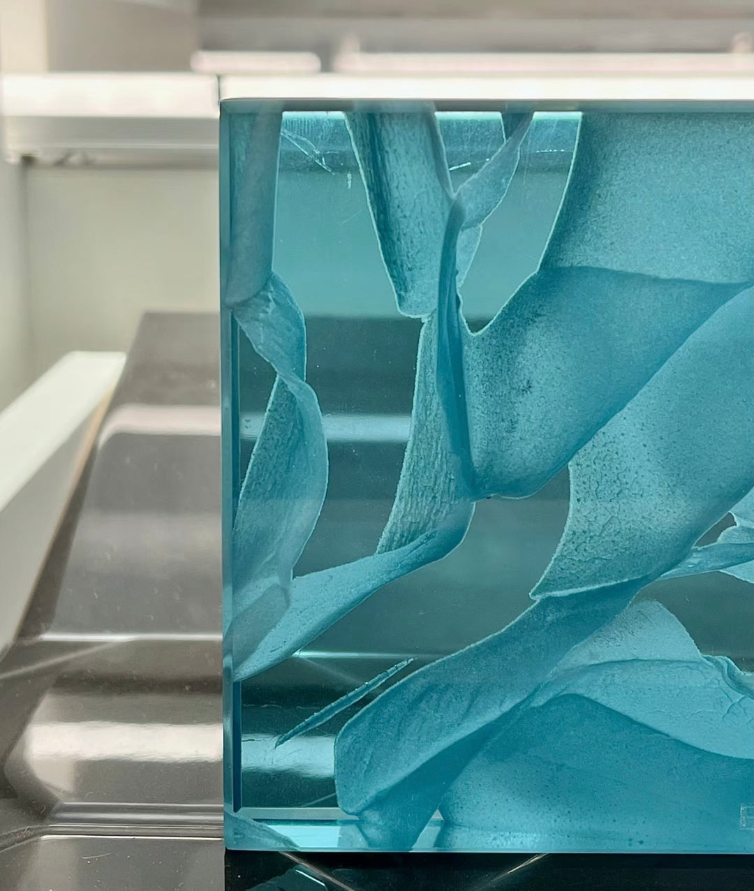 Translucent jade glass panel detail highlighting layered glass texture